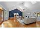 Inviting living room filled with natural light, highlighting hardwood floors and french doors at 3418 Carriage Trl, Hillsborough, NC 27278