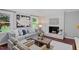 Bright living room features a fireplace, large windows, and comfortable seating, perfect for relaxing at 3418 Carriage Trl, Hillsborough, NC 27278