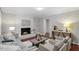 Inviting living room boasts a fireplace, hardwood floors, and comfortable seating for relaxation at 3418 Carriage Trl, Hillsborough, NC 27278