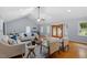 Spacious living room featuring hardwood floors, a ceiling fan, and french doors leading to outdoor at 3418 Carriage Trl, Hillsborough, NC 27278