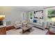 Cozy living room featuring hardwood floors, ample natural light, and stylish, comfortable seating at 3418 Carriage Trl, Hillsborough, NC 27278