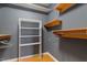 Walk-in closet with wood floors, built-in shelving and lots of storage space at 3418 Carriage Trl, Hillsborough, NC 27278