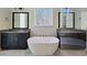 Bathroom features a large soaking tub between two black granite top vanities and large mirrors at 35 Big Bear Dr, Pittsboro, NC 27312