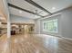 Bright living room with hardwood floors, ceiling fan, and expansive windows overlooking the outdoors at 35 Big Bear Dr, Pittsboro, NC 27312