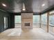 Screened in porch with stacked stone fireplace and ceiling fan at 35 Big Bear Dr, Pittsboro, NC 27312