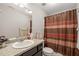 Functional bathroom with vanity, toilet, and shower with curtain at 357 Sherrill Farm Dr, Benson, NC 27504
