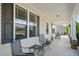 Spacious covered front porch with seating, providing an outdoor living space and views of the home's exterior at 357 Sherrill Farm Dr, Benson, NC 27504