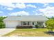 Charming single-story home with well-maintained lawn and inviting front porch, complemented by lush landscaping at 357 Sherrill Farm Dr, Benson, NC 27504