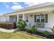 Inviting front porch featuring decorative plants and seating, offering a cozy outdoor space with lovely curb appeal at 357 Sherrill Farm Dr, Benson, NC 27504