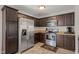 Kitchen featuring stainless steel appliances, granite countertops, and ample cabinet space at 357 Sherrill Farm Dr, Benson, NC 27504