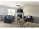 Cozy living room featuring a fireplace, ceiling fan, neutral walls, and comfortable seating at 357 Sherrill Farm Dr, Benson, NC 27504