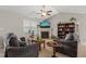 Cozy living room features a fireplace, ceiling fan, and comfortable seating arrangement creating a welcoming atmosphere at 357 Sherrill Farm Dr, Benson, NC 27504