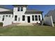 A well-maintained backyard features a classic white house and a lovely grass lawn, perfect for outdoor enjoyment at 367 Whitley Ridge Dr, Clayton, NC 27527