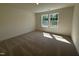 Well-lit bedroom with two large windows and neutral carpet at 367 Whitley Ridge Dr, Clayton, NC 27527