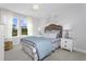 Bedroom with a decorative headboard and two windows with white sheer curtains at 367 Whitley Ridge Dr, Clayton, NC 27527