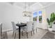 Elegant dining room with stylish chandelier, seating for six, and a large window at 367 Whitley Ridge Dr, Clayton, NC 27527
