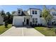 Beautiful new construction home featuring a modern design with white siding and a well-manicured lawn at 367 Whitley Ridge Dr, Clayton, NC 27527