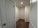 Hallway with white doors and trim, and durable wood-look flooring at 367 Whitley Ridge Dr, Clayton, NC 27527