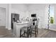 Bright kitchen with white cabinetry, stainless steel appliances, and a breakfast bar with seating at 367 Whitley Ridge Dr, Clayton, NC 27527