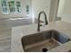 Stainless steel kitchen sink with a view into the spacious living room at 367 Whitley Ridge Dr, Clayton, NC 27527
