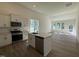 Modern kitchen featuring white cabinets, stainless steel appliances, and an island with a sink at 367 Whitley Ridge Dr, Clayton, NC 27527