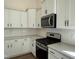 Kitchen showcasing white cabinets, subway tile backsplash, stainless steel oven and microwave appliances at 367 Whitley Ridge Dr, Clayton, NC 27527