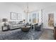 Cozy living room with a plush sofa, armchairs, a stylish rug, and ample natural light at 367 Whitley Ridge Dr, Clayton, NC 27527