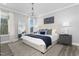 Bright, airy main bedroom featuring a large window, chandelier, and an ensuite bathroom at 367 Whitley Ridge Dr, Clayton, NC 27527