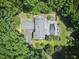 Aerial view of the property featuring a house, pool, and surrounding lush greenery at 37 Wedgewood Rd, Chapel Hill, NC 27514
