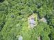 Aerial view of home with pool surrounded by lush green trees, offering a private retreat at 37 Wedgewood Rd, Chapel Hill, NC 27514