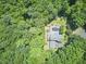 Aerial view of a private property surrounded by lush green trees, pool and large home at 37 Wedgewood Rd, Chapel Hill, NC 27514