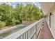 Balcony featuring a wooden deck, a stone wall and covered pool in the backyard at 37 Wedgewood Rd, Chapel Hill, NC 27514