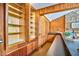 Bar area featuring wood paneling, built-in shelves, and a sleek countertop at 37 Wedgewood Rd, Chapel Hill, NC 27514