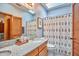 Bathroom showcasing granite countertop vanity, skylight, and shower with patterned curtain at 37 Wedgewood Rd, Chapel Hill, NC 27514