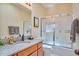 Bathroom with granite countertop vanity, shower and tub combo with glass doors at 37 Wedgewood Rd, Chapel Hill, NC 27514