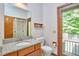 Bathroom with granite vanity, mirror, toilet, and exterior access door at 37 Wedgewood Rd, Chapel Hill, NC 27514