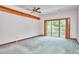 Bedroom with gray carpet, a ceiling fan, and sliding doors to a balcony at 37 Wedgewood Rd, Chapel Hill, NC 27514