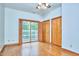 Bedroom with wooden floors, doors leading to the balcony and a closet at 37 Wedgewood Rd, Chapel Hill, NC 27514