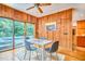 Bright dining area with wood walls, ceiling fan and view of pool at 37 Wedgewood Rd, Chapel Hill, NC 27514