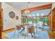 Bright dining room features hardwood floors, skylights, a glass table, and views of the outdoors at 37 Wedgewood Rd, Chapel Hill, NC 27514