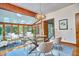 Bright dining room features hardwood floors, skylights, a glass table, and views of the outdoors at 37 Wedgewood Rd, Chapel Hill, NC 27514