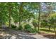 Exterior shot of a two-story home surrounded by mature trees and established landscaping at 37 Wedgewood Rd, Chapel Hill, NC 27514
