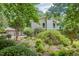 Beautiful two-story home with lush greenery, mature trees, and well-maintained landscaping at 37 Wedgewood Rd, Chapel Hill, NC 27514
