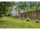 A two-story home with a stone wall, established landscaping and mature shade trees at 37 Wedgewood Rd, Chapel Hill, NC 27514