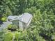 Exterior view of a charming home nestled among lush greenery, exuding tranquility at 37 Wedgewood Rd, Chapel Hill, NC 27514