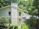 Two-story home with stone accents surrounded by lush greenery, creating a serene curb appeal at 37 Wedgewood Rd, Chapel Hill, NC 27514