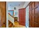 Warm foyer features hardwood floors, an open staircase, and a view of the exterior at 37 Wedgewood Rd, Chapel Hill, NC 27514