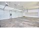 Spacious three-car garage with white walls, concrete floor, and overhead lighting at 37 Wedgewood Rd, Chapel Hill, NC 27514