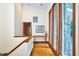 Hallway with wooden floors, stone siding, and plenty of natural light from the large windows at 37 Wedgewood Rd, Chapel Hill, NC 27514