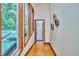 Bright hallway featuring hardwood floors, large windows, and stylish decorative wall art at 37 Wedgewood Rd, Chapel Hill, NC 27514
